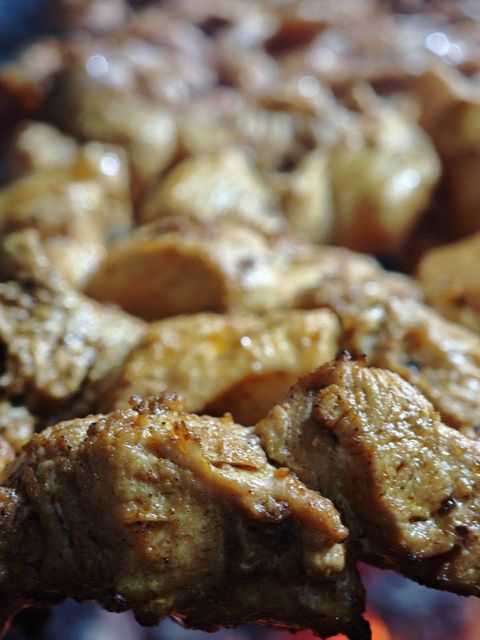 Close-up of chicken sizzling on the charcoal grill at Jerusalem Restaurant Patong